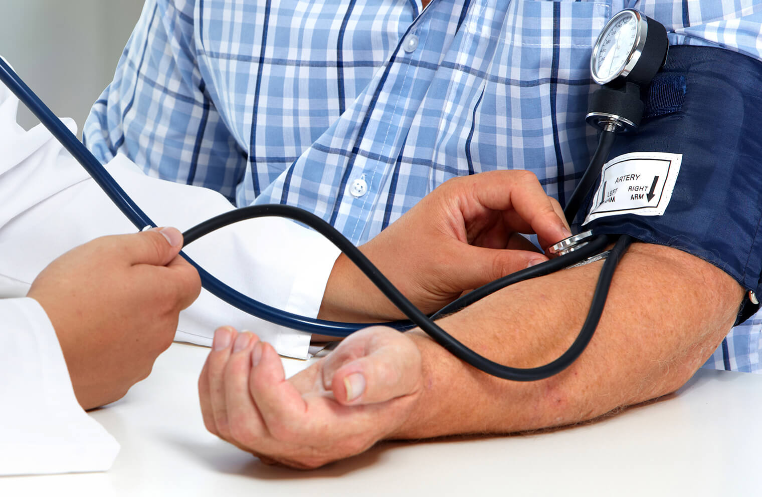 A man gets his blood pressure taken as part of preventive care services. 